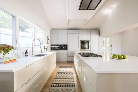 a kitchen with a sink stove and cabinets