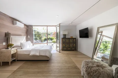 a bedroom with furniture and a flat screen tv