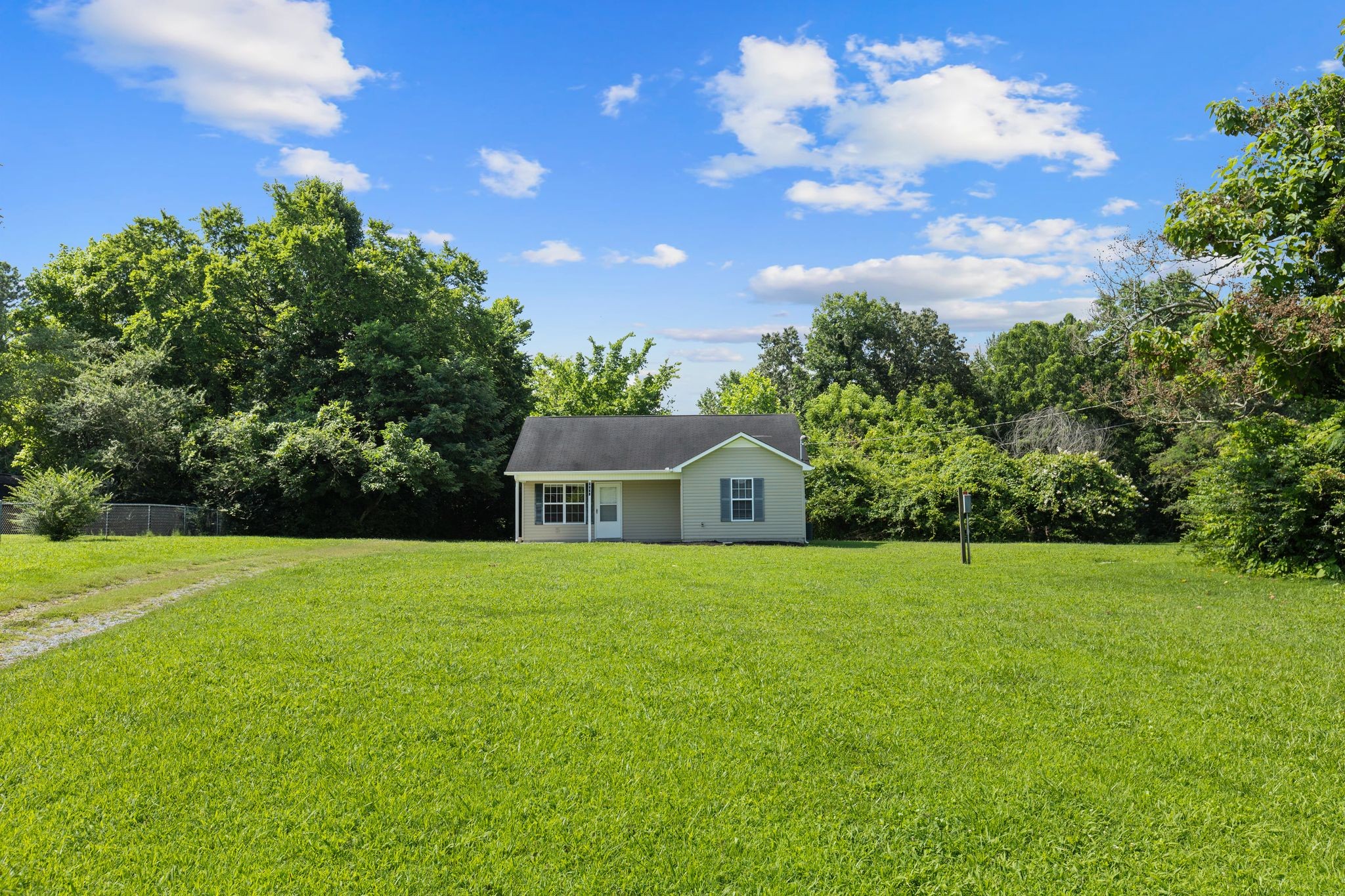 7215 Horn Tavern Road Fairview, TN 37062 - Photo 1 of 14 a front view of a house with a yard and trees