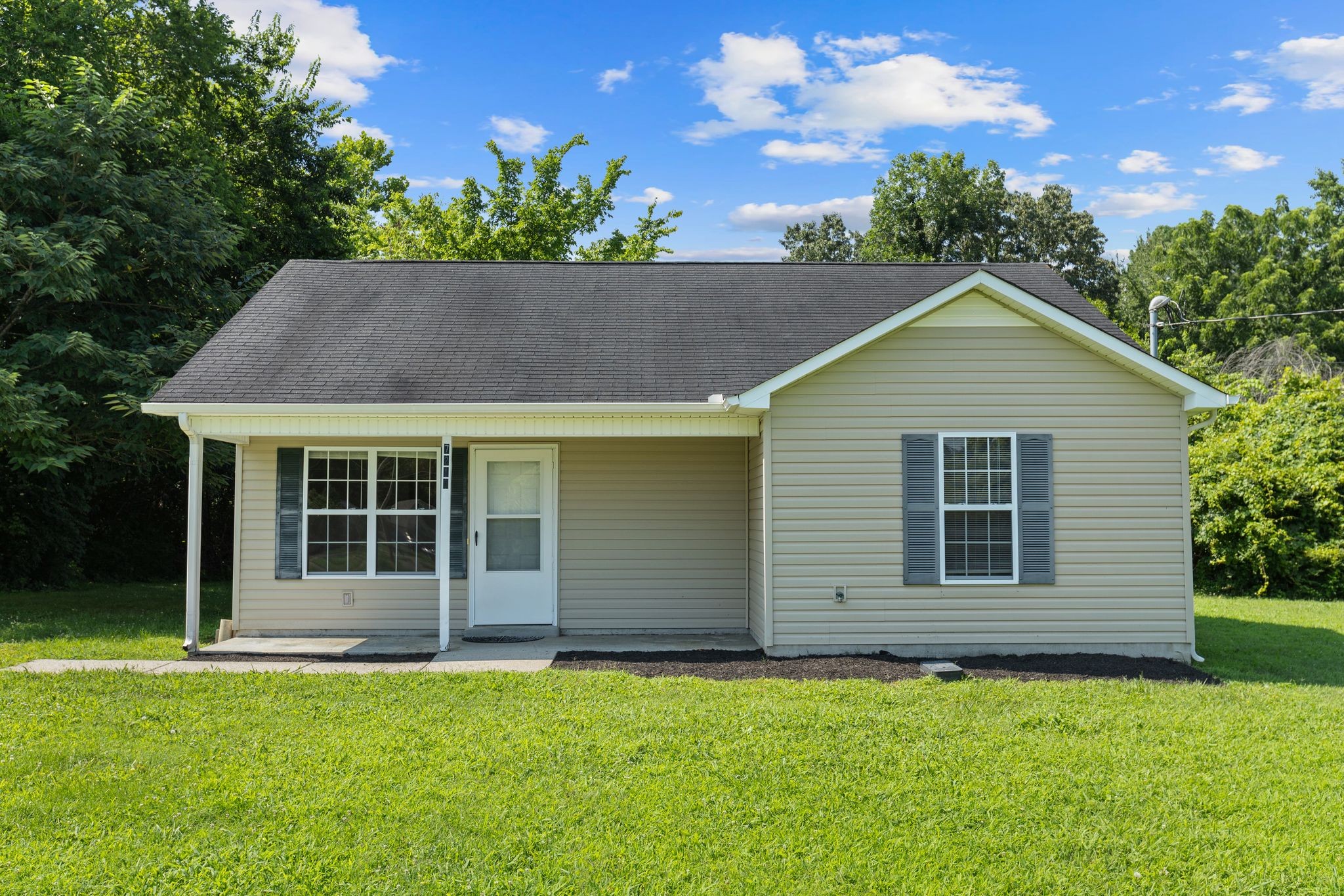 7215 Horn Tavern Road Fairview, TN 37062 - Photo 2 of 14 a front view of a house with a garden
