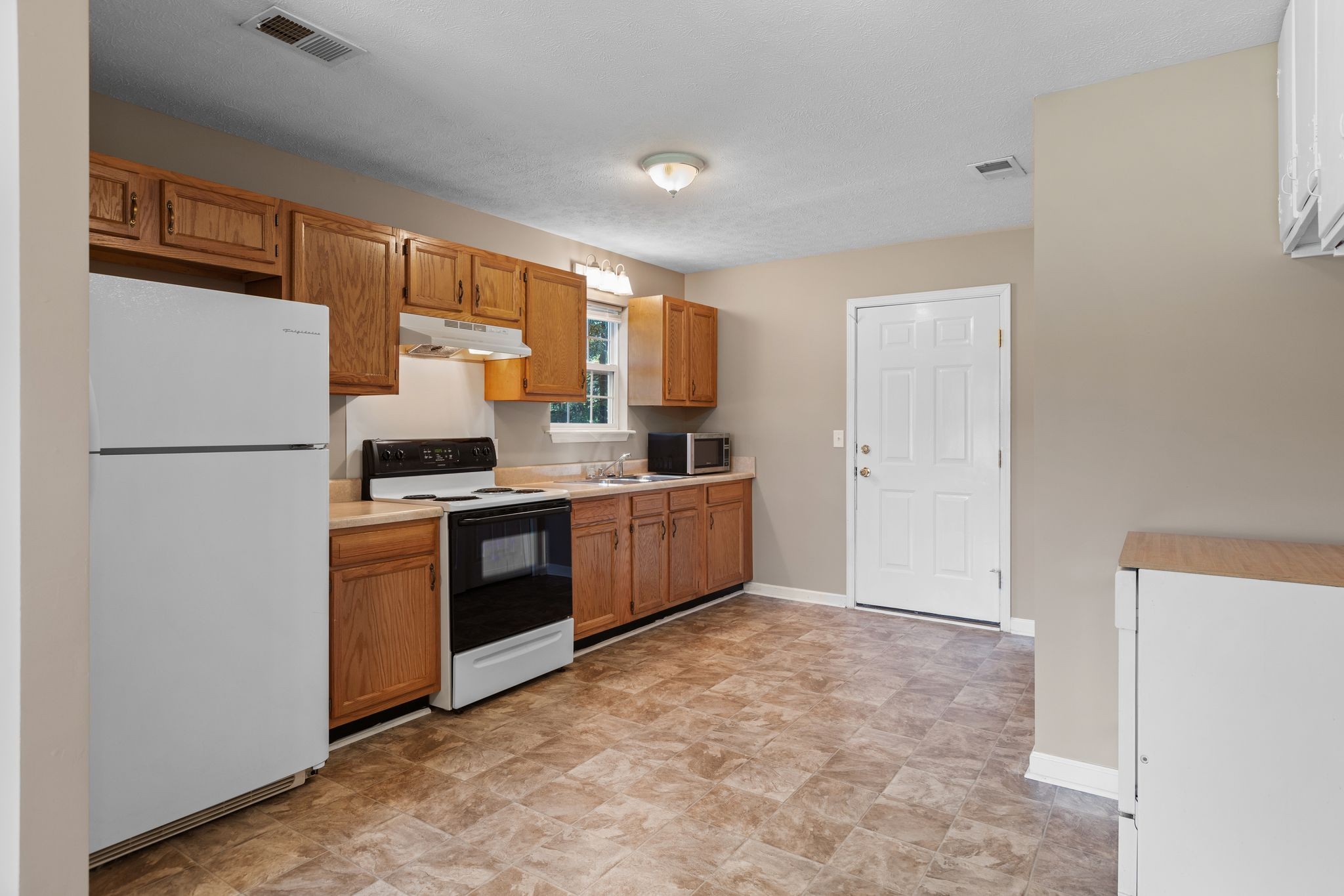 7215 Horn Tavern Road Fairview, TN 37062 - Photo 5 of 14 a kitchen with stainless steel appliances a refrigerator and a stove top oven