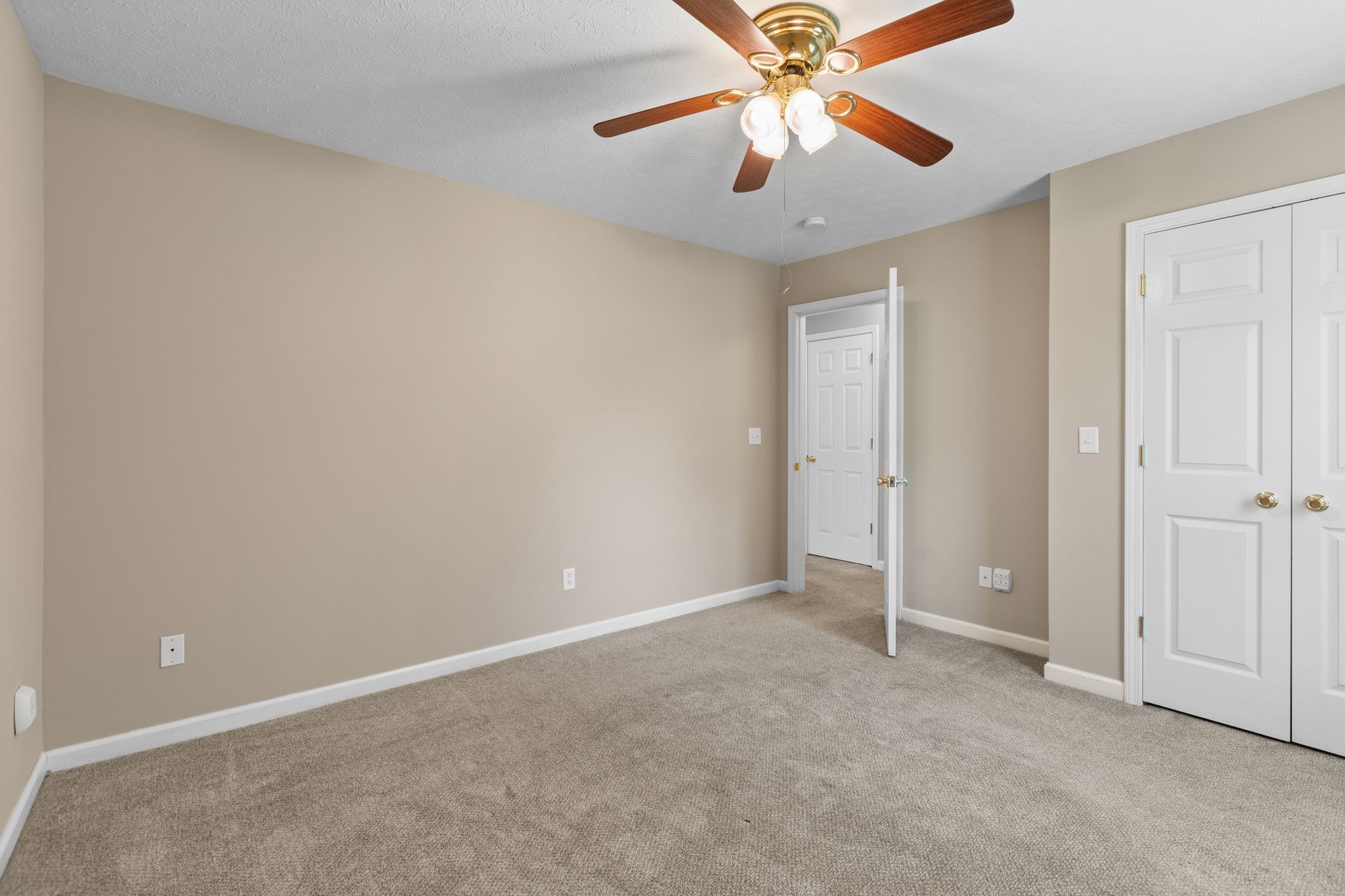 7215 Horn Tavern Road Fairview, TN 37062 - Photo 9 of 14 an empty room with closet and a chandelier fan