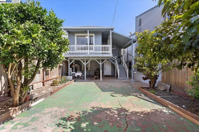 a view of a backyard with plants and a patio