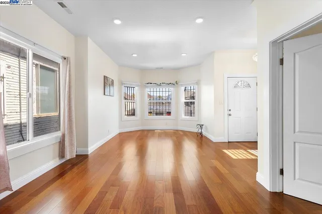 a living room with furniture a rug and a large window