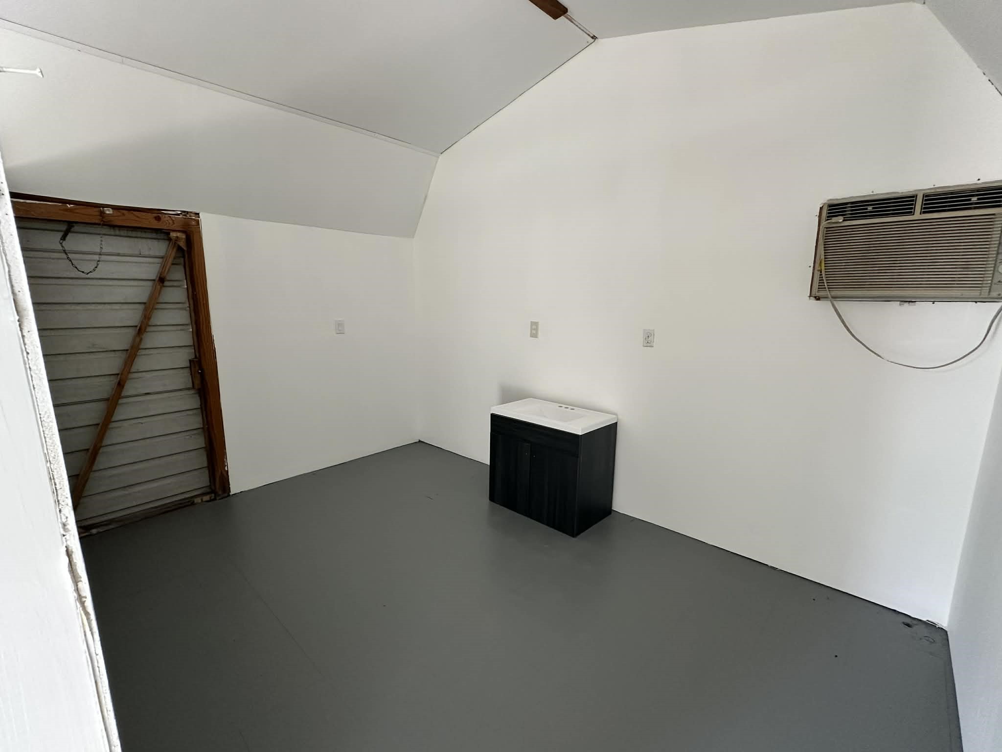 614 Fm 1406 Road Winnie, TX 77665 - Photo 18 of 19 a view of a room with wooden floor and white walls
