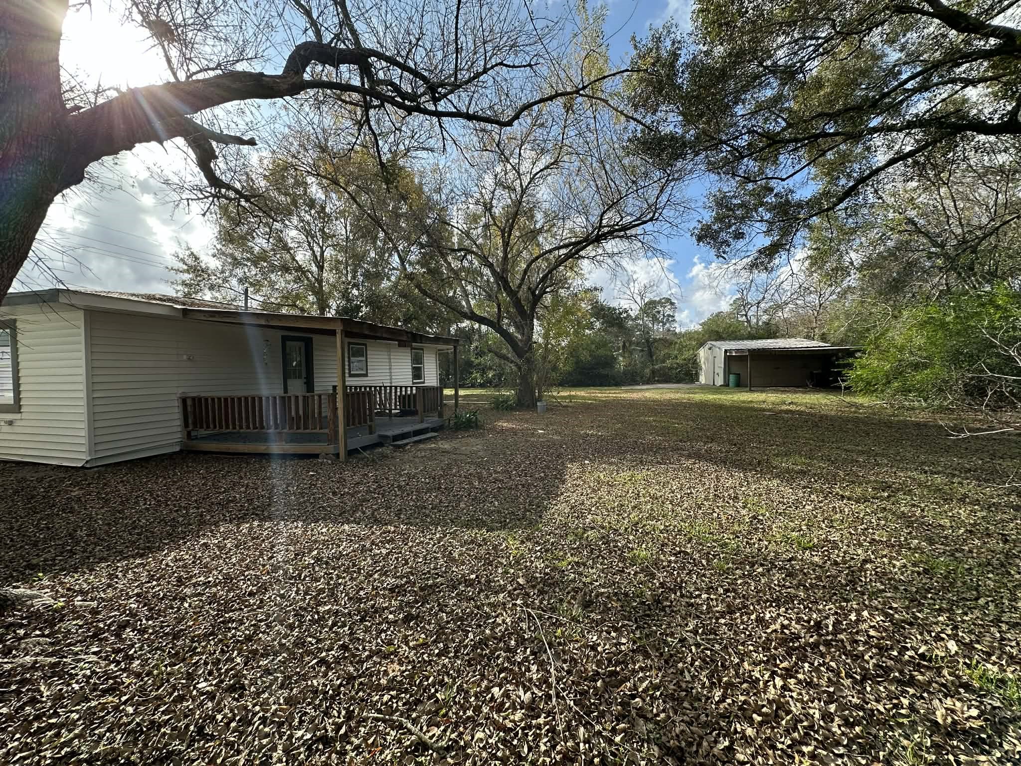 614 Fm 1406 Road Winnie, TX 77665 - Photo 19 of 19 a front view of a house with a yard