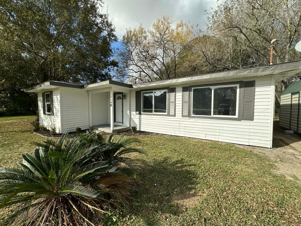 614 Fm 1406 Road Winnie, TX 77665 - Photo 2 of 19 a house with trees in front of it