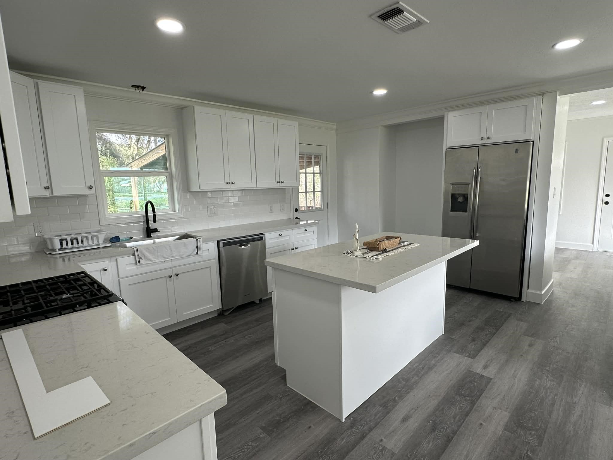 614 Fm 1406 Road Winnie, TX 77665 - Photo 7 of 19 a kitchen with a sink stove a refrigerator and cabinets