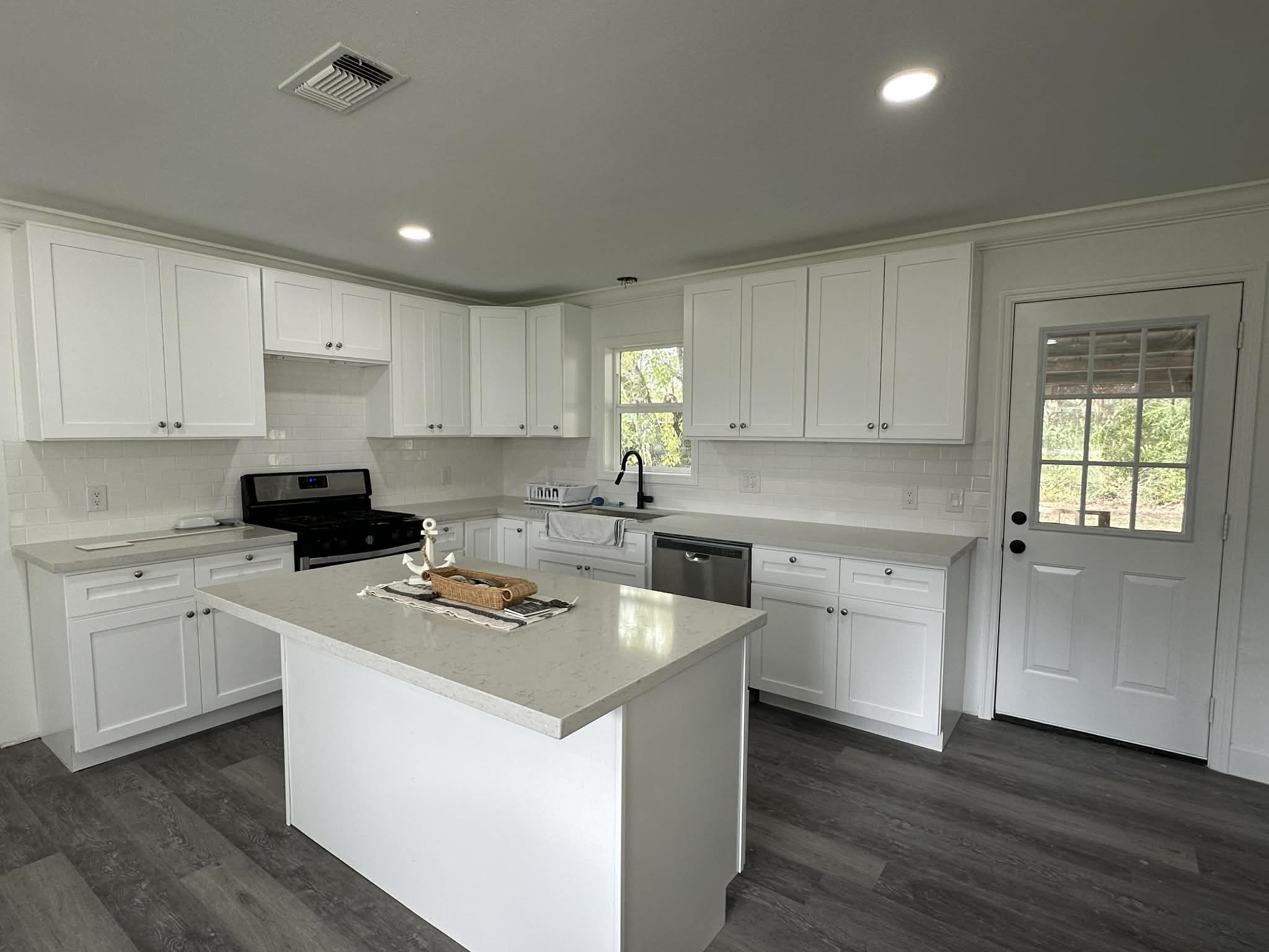 614 Fm 1406 Road Winnie, TX 77665 - Photo 8 of 19 a kitchen with granite countertop white cabinets sink and white appliances