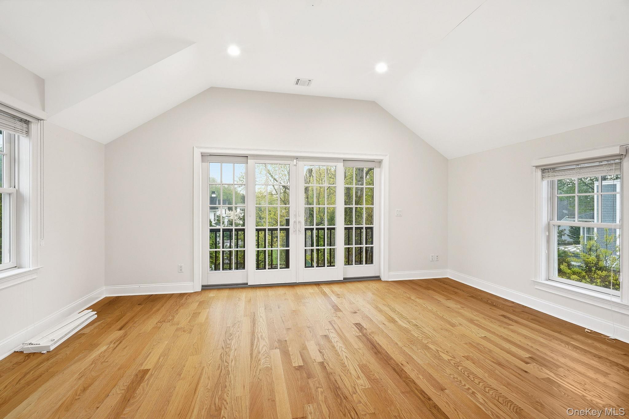 228 Central Avenue Rye, NY 10580 - Photo 12 of 24 a view of an empty room with wooden floor and a window