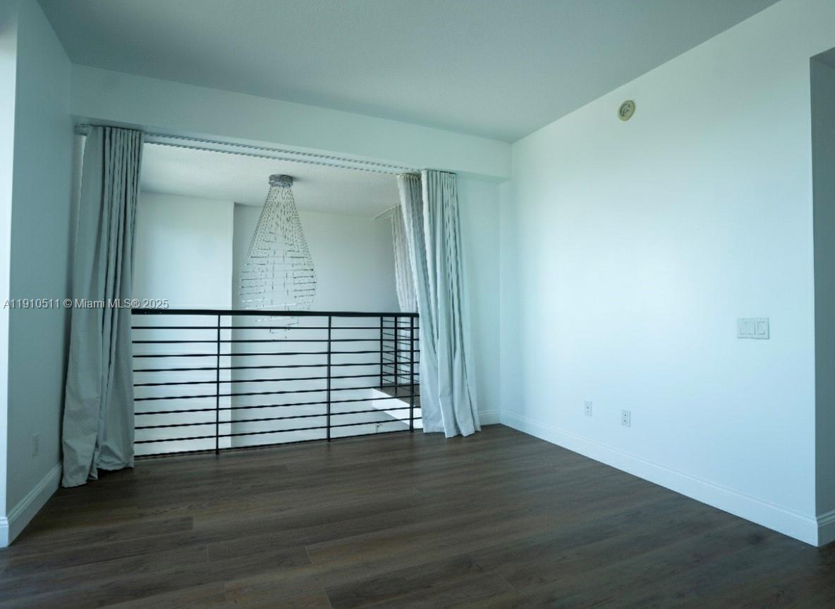 60 Southwest 13th Street, Unit 4805 Miami, FL 33130 - Photo 9 of 10 an empty room with wooden floor and windows