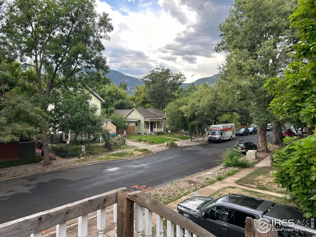 a view of a street with cars on road