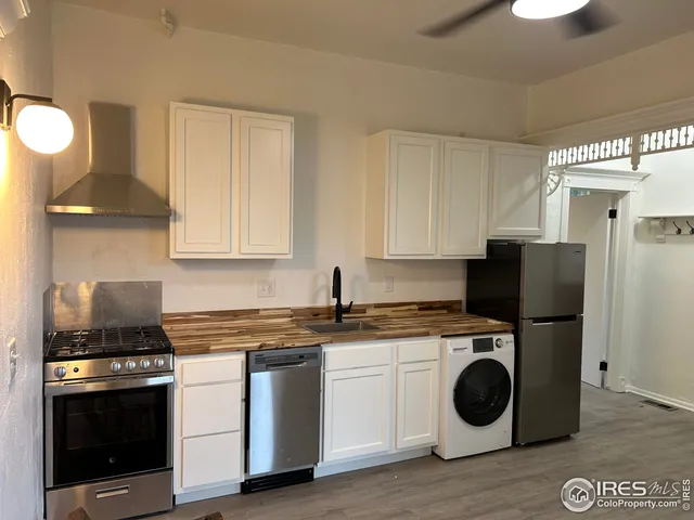 a kitchen with a stove and a sink