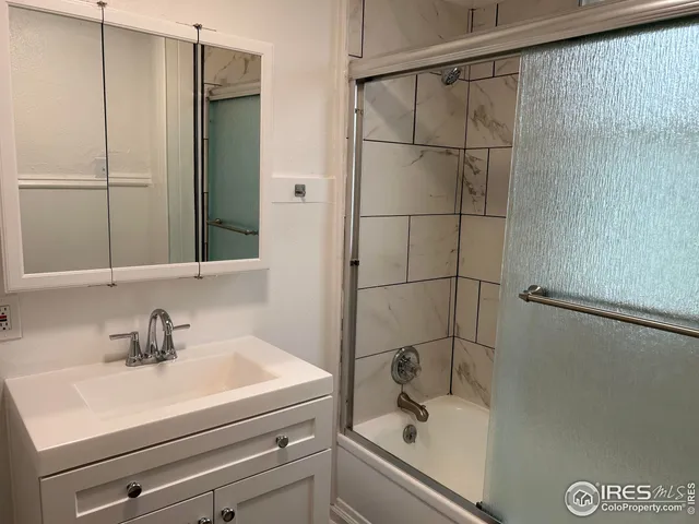 a bathroom with a sink and a shower