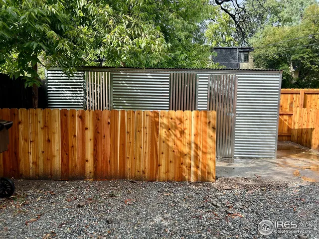 a view of a door with a wooden fence