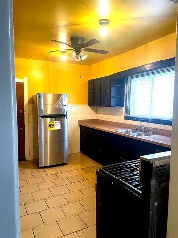 a kitchen with a stove and a refrigerator