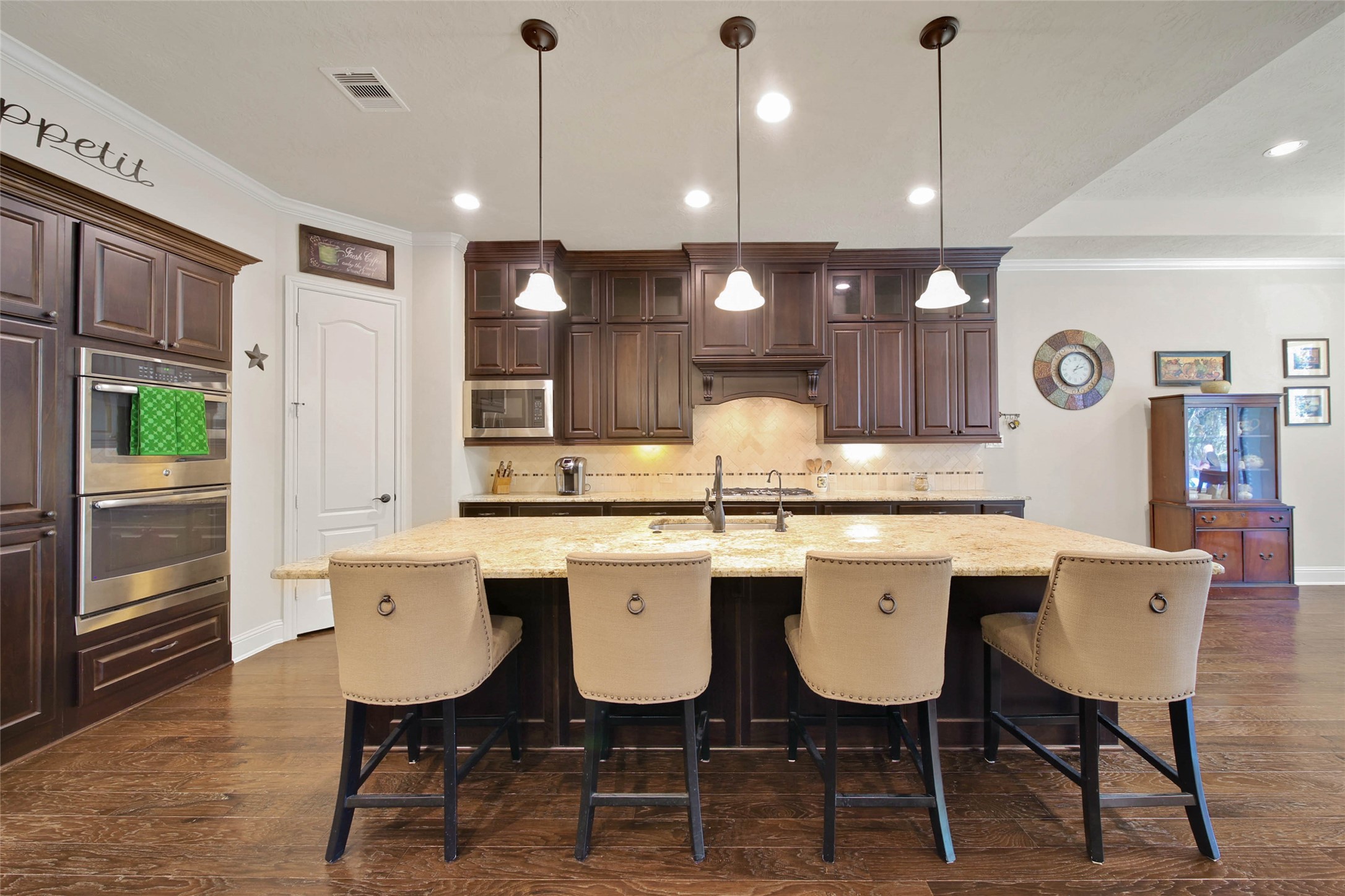 3234 Explorer Way Conroe, TX 77301 - Photo 15 of 44 a kitchen with a table chairs sink and wooden floor