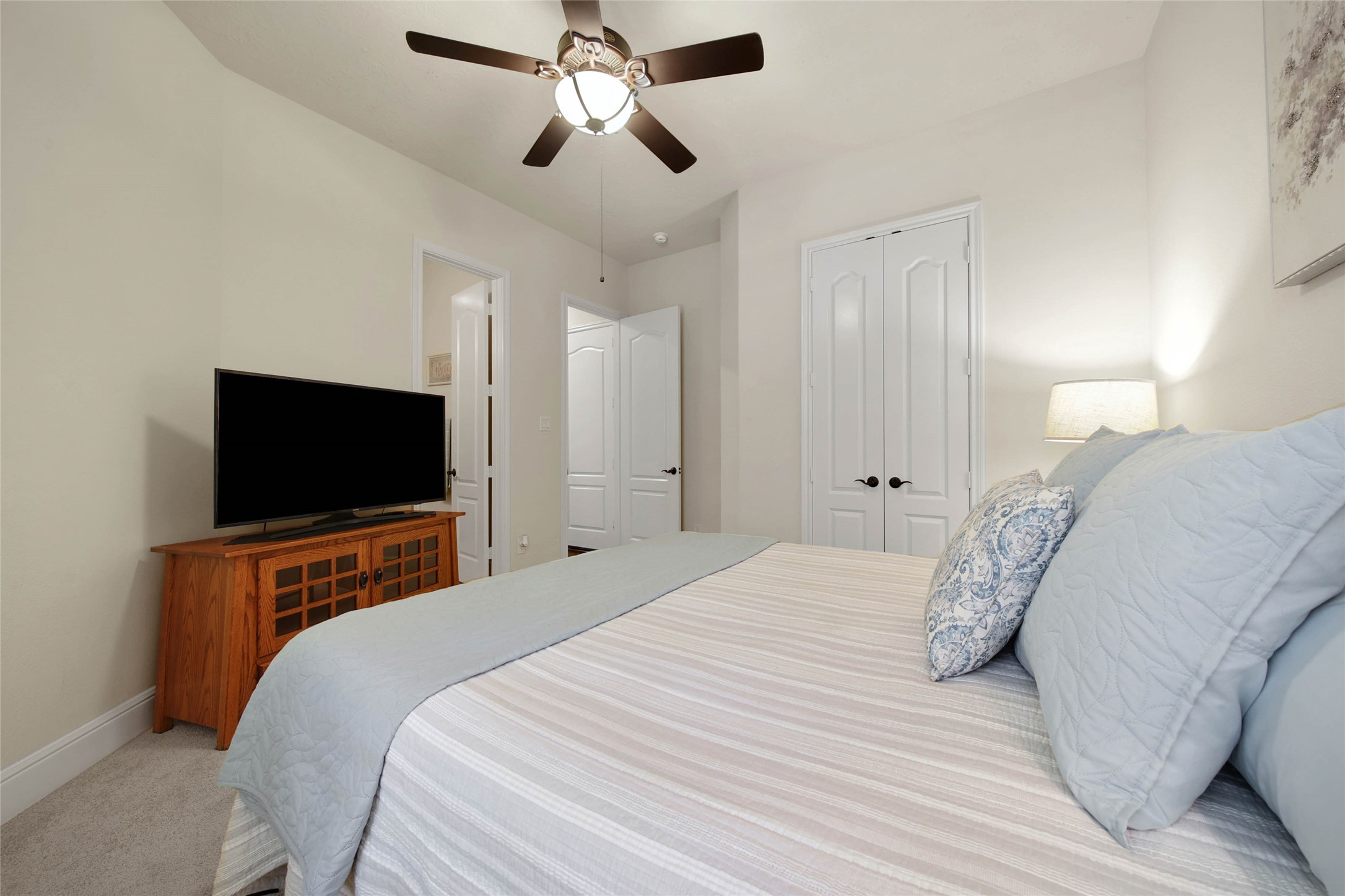 3234 Explorer Way Conroe, TX 77301 - Photo 31 of 44 a bedroom with a bed and a flat screen tv