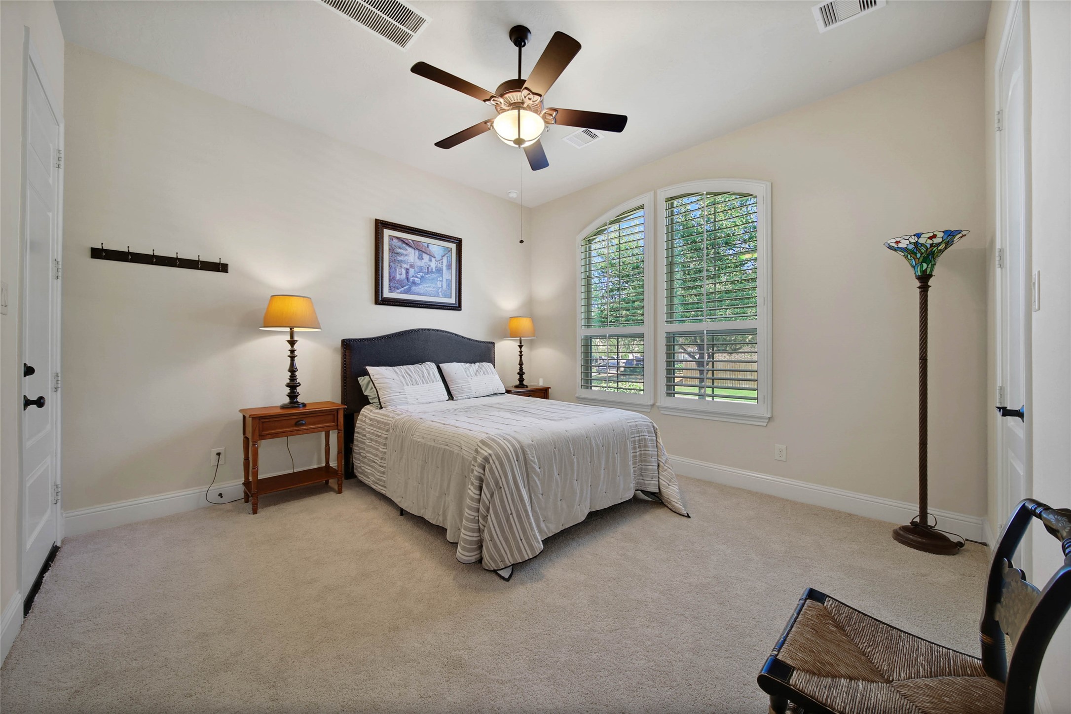3234 Explorer Way Conroe, TX 77301 - Photo 35 of 44 a bedroom with a bed a couch and a ceiling fan