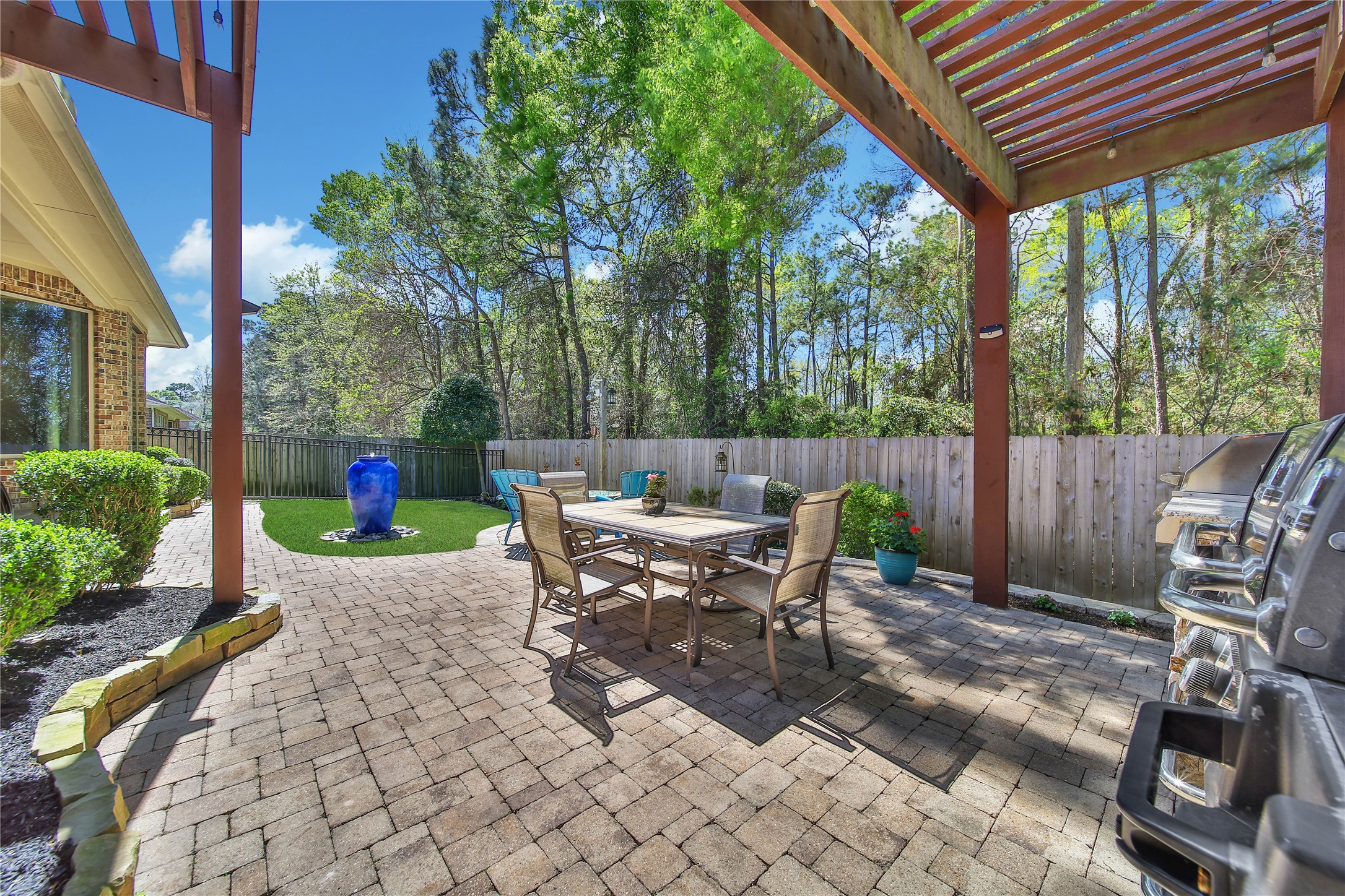 3234 Explorer Way Conroe, TX 77301 - Photo 43 of 44 a view of a patio with table and chairs potted plants and large tree
