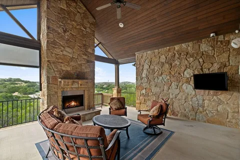 a living room with furniture a flat screen tv and a fireplace