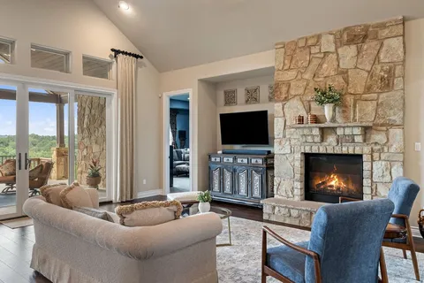 a living room with furniture a flat screen tv and a fireplace