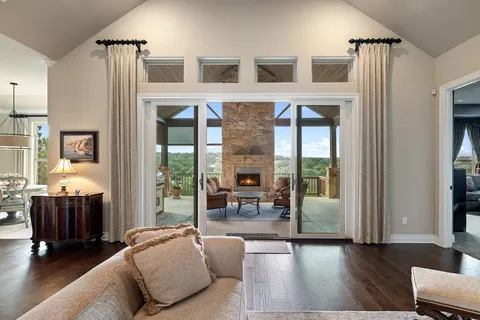 a living room with furniture and large windows