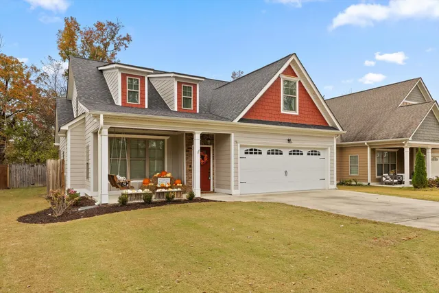 a front view of a house with glass windows and yard