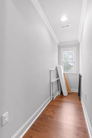 a view of an empty room with chair and a window