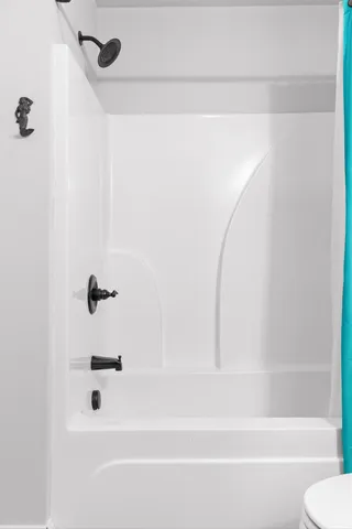 a bathroom with a shower and a bath tub