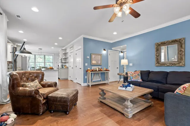 a living room with furniture and wooden floor