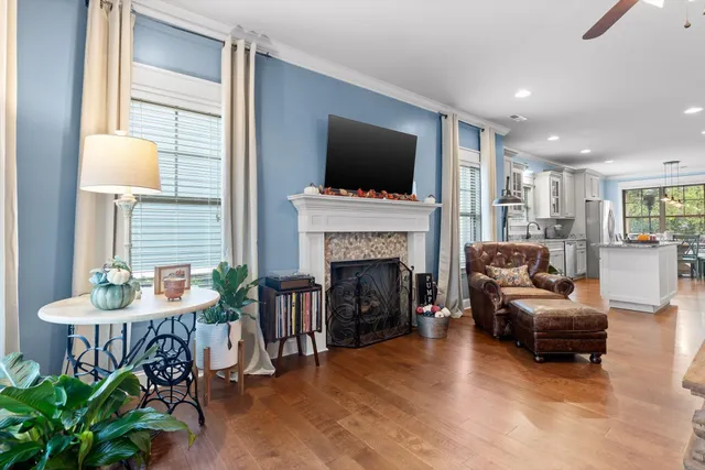 a living room with furniture a flat screen tv and a fireplace