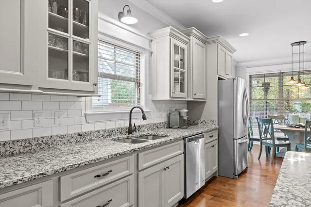 a kitchen with granite countertop a sink and cabinets