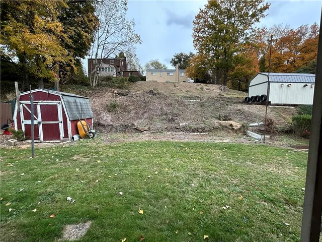 a backyard of a house with table and chairs