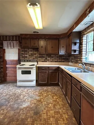 a kitchen with a stove top oven sink and cabinets