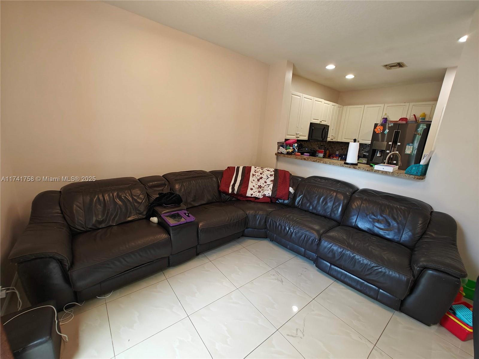 2583 Riverside Drive, Unit 2583 Coral Springs, FL 33065 - Photo 15 of 33 a living room with furniture and a couch