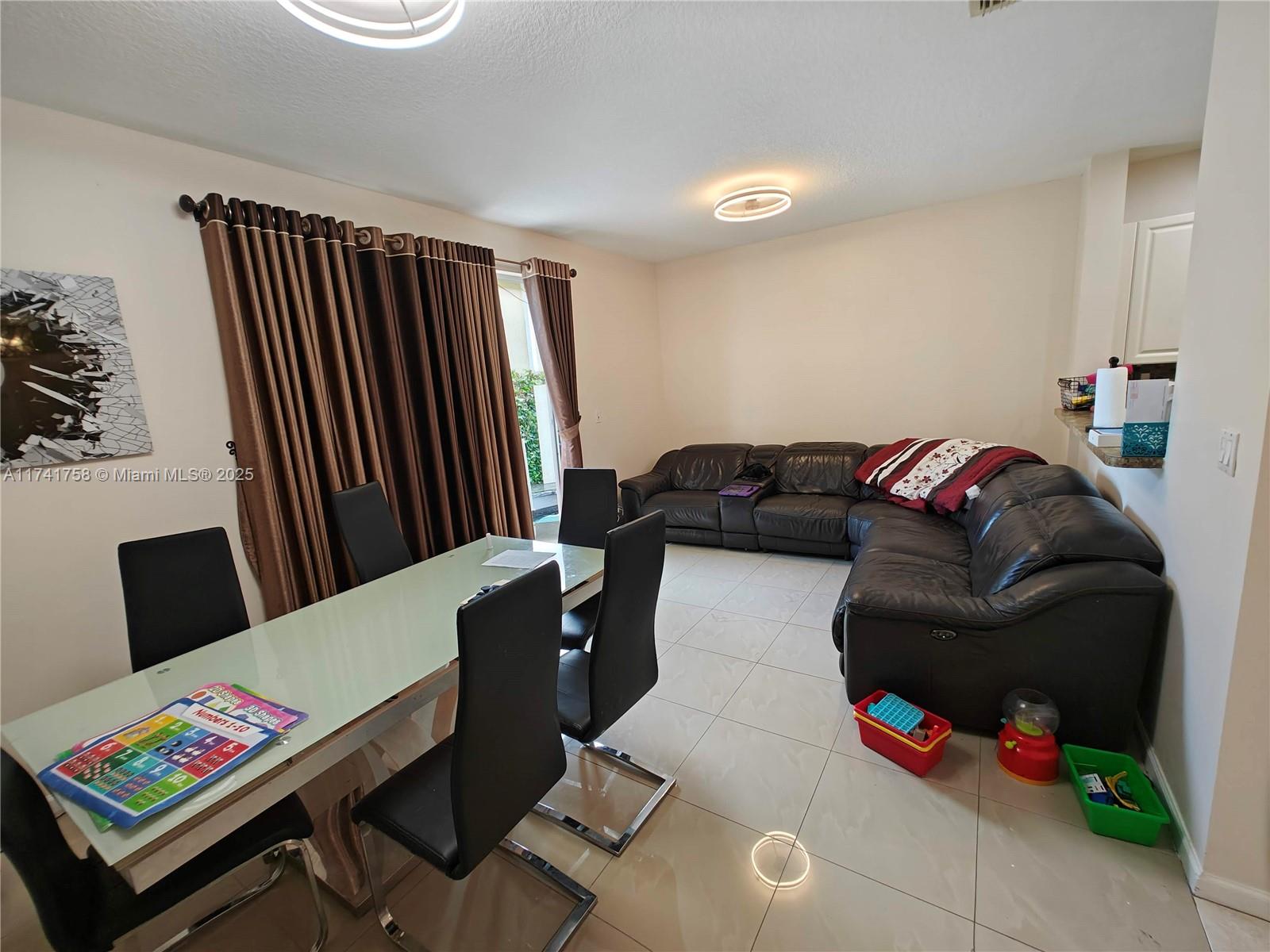 2583 Riverside Drive, Unit 2583 Coral Springs, FL 33065 - Photo 18 of 33 a living room with furniture and a flat screen tv