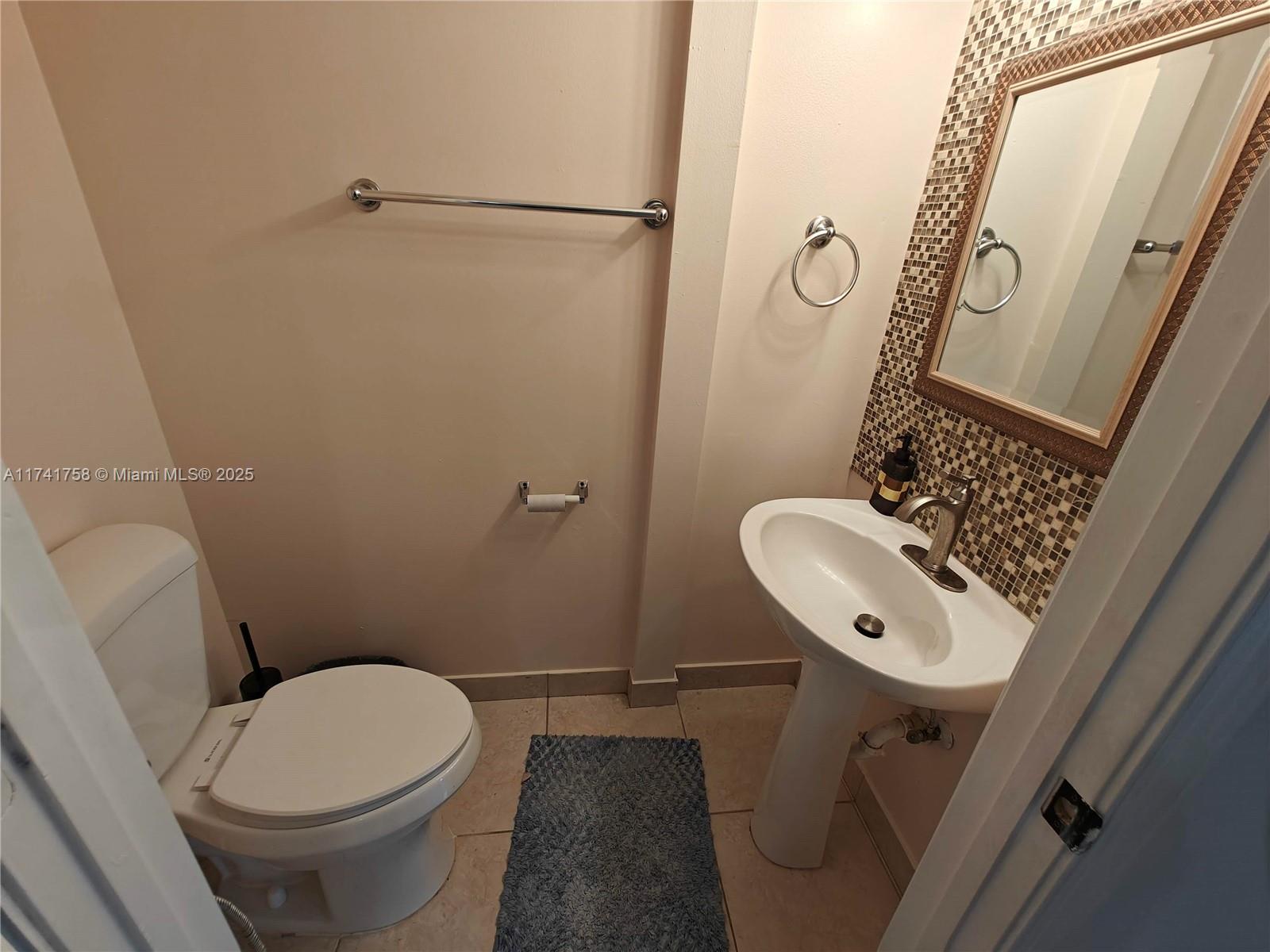 2583 Riverside Drive, Unit 2583 Coral Springs, FL 33065 - Photo 20 of 33 a bathroom with a toilet sink and shower