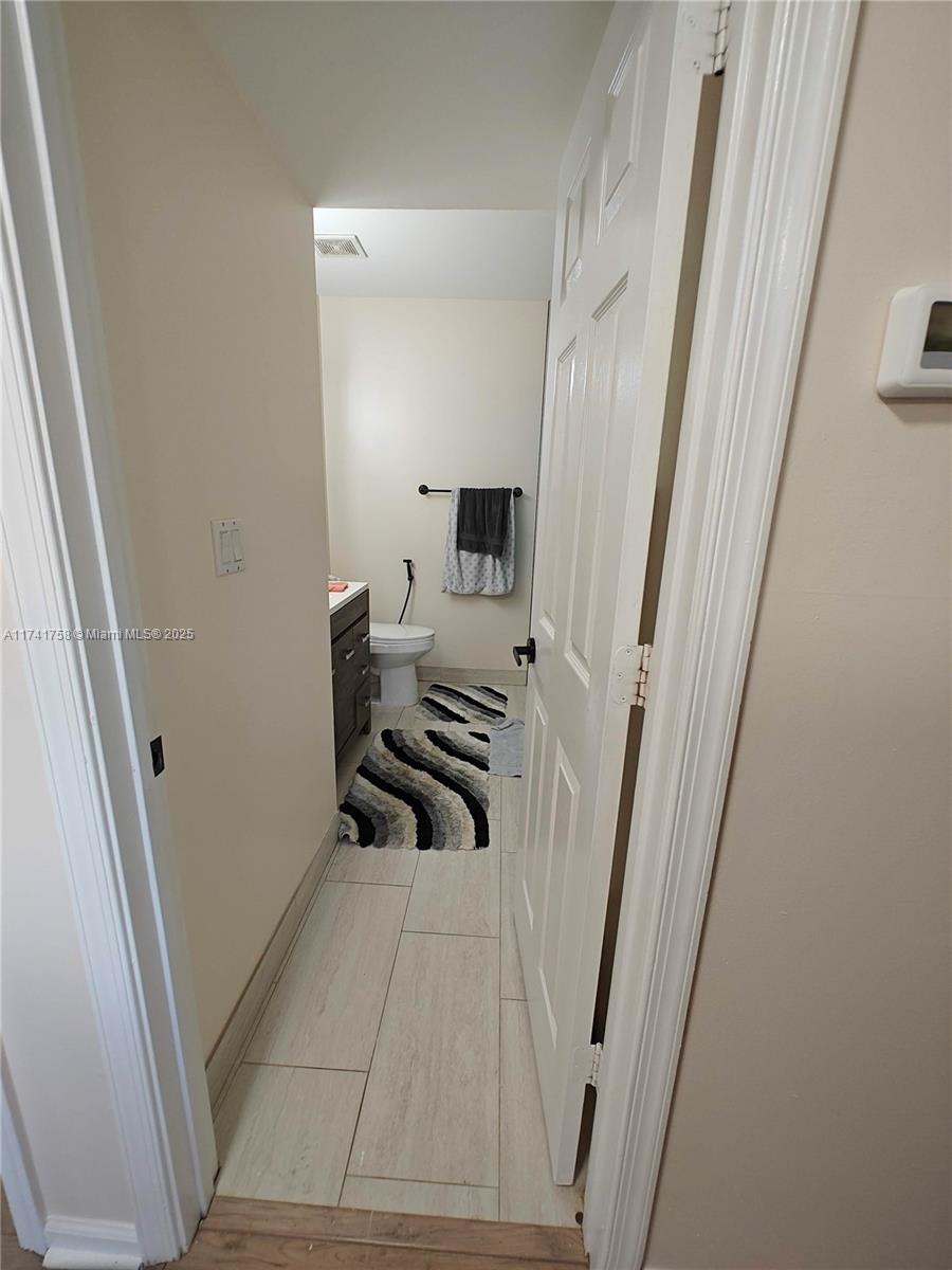 2583 Riverside Drive, Unit 2583 Coral Springs, FL 33065 - Photo 23 of 33 a view of a bathroom with a sink and a mirror