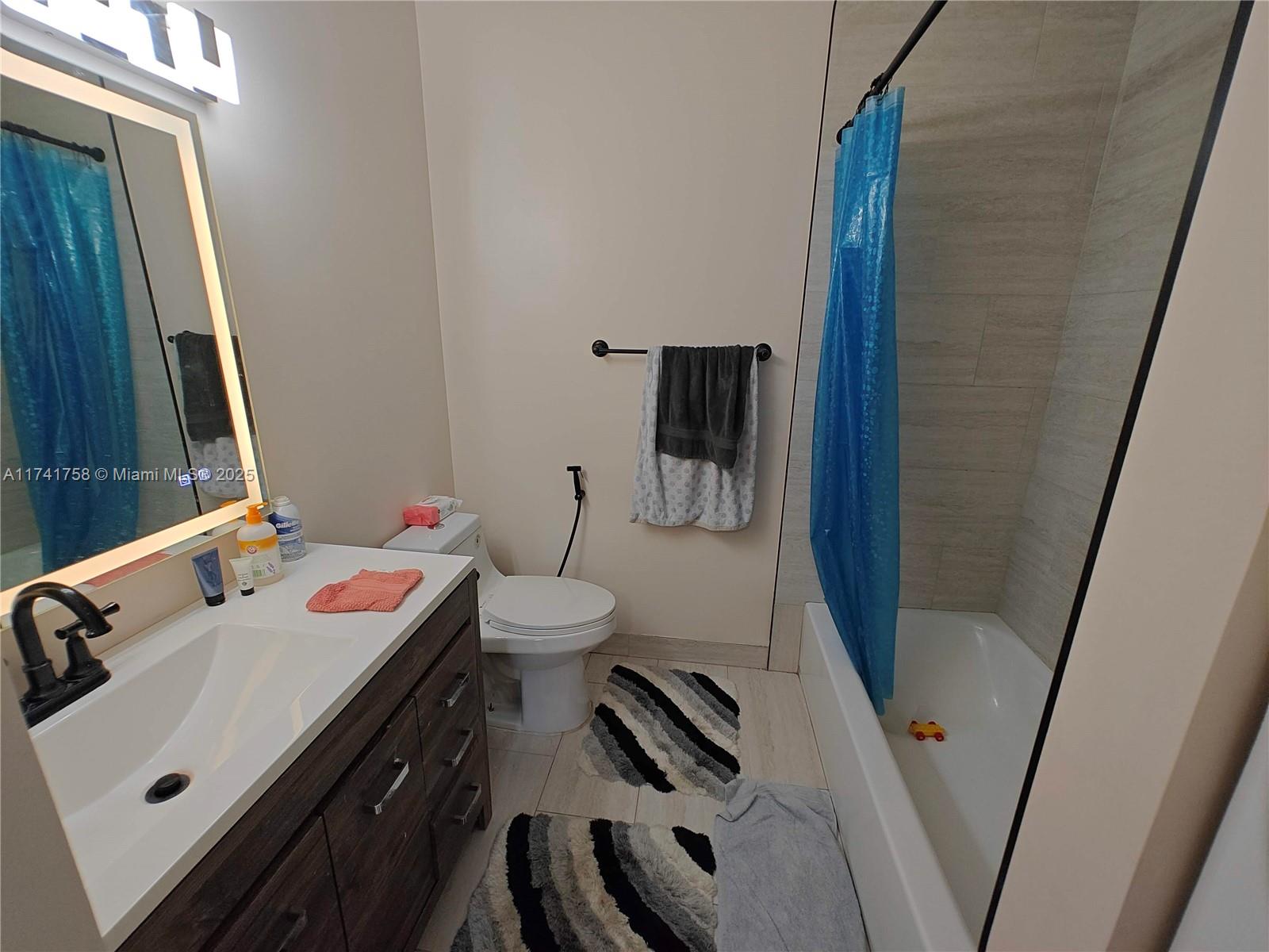 2583 Riverside Drive, Unit 2583 Coral Springs, FL 33065 - Photo 24 of 33 a bathroom with a sink and a mirror