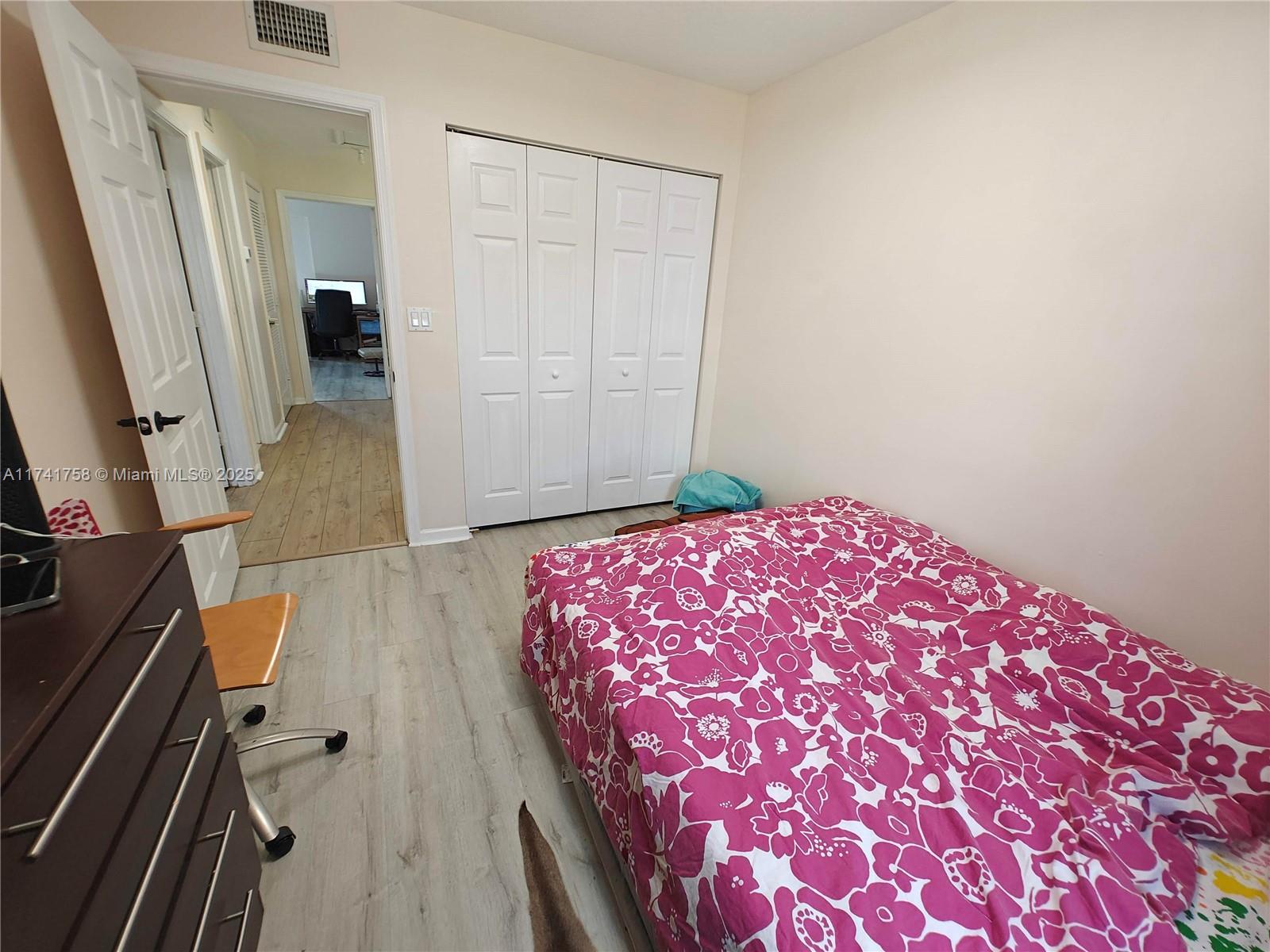 2583 Riverside Drive, Unit 2583 Coral Springs, FL 33065 - Photo 28 of 33 a bedroom with a bed and a mirror