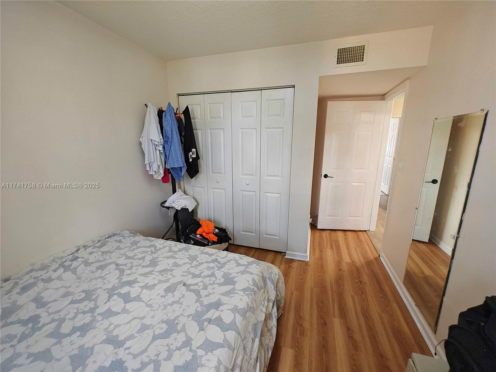 2583 Riverside Drive, Unit 2583 Coral Springs, FL 33065 - Photo 30 of 33 a bed room with a bed and a mirror