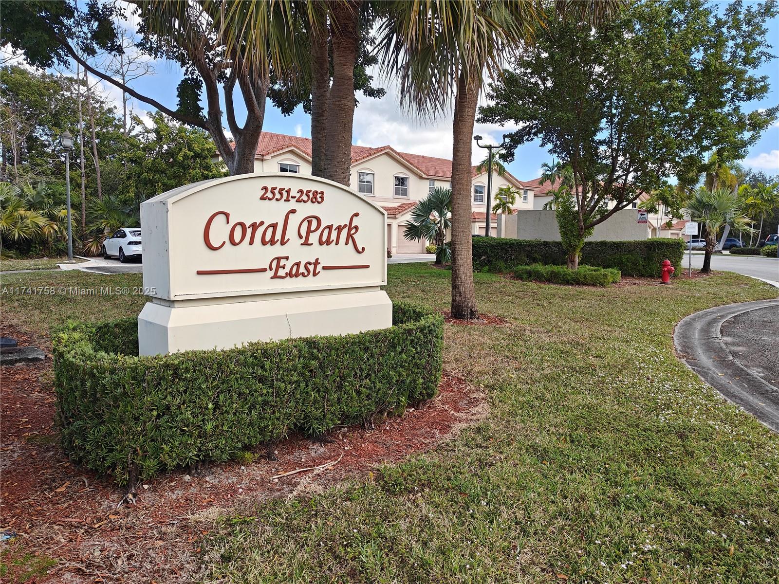 2583 Riverside Drive, Unit 2583 Coral Springs, FL 33065 - Photo 3 of 33 a sign on the side of the road