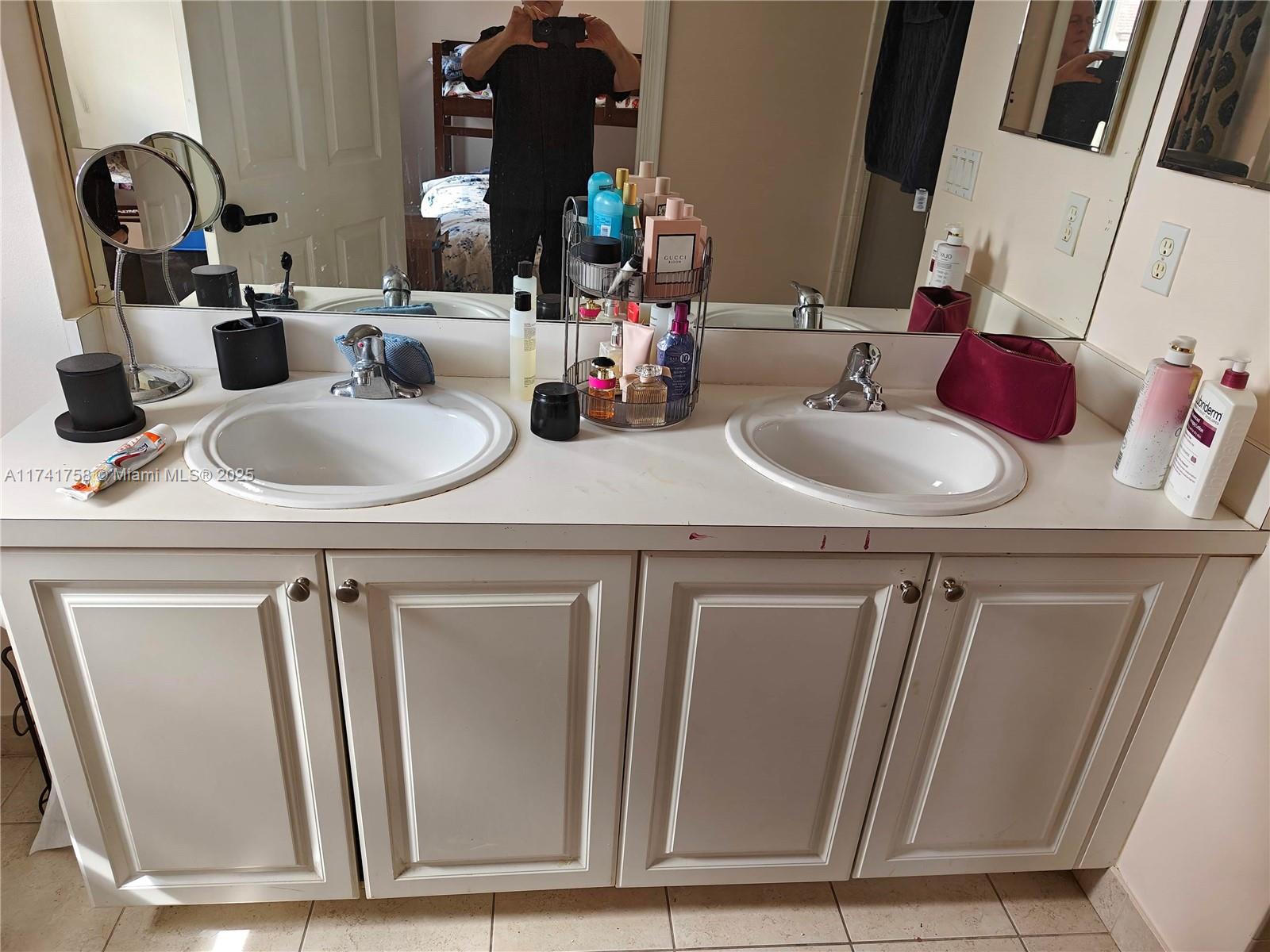 2583 Riverside Drive, Unit 2583 Coral Springs, FL 33065 - Photo 32 of 33 a bathroom with a sink and a mirror