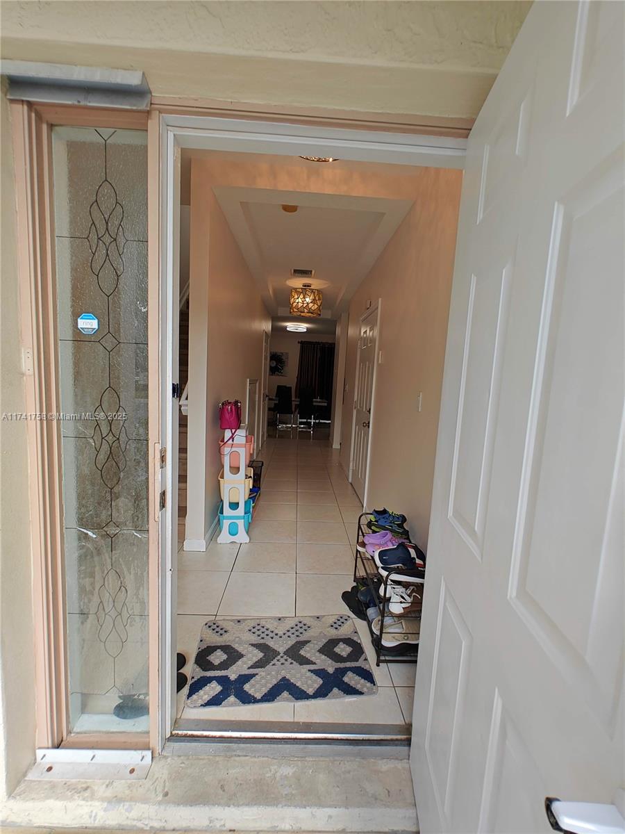 2583 Riverside Drive, Unit 2583 Coral Springs, FL 33065 - Photo 5 of 33 a hallway with white walls and furniture