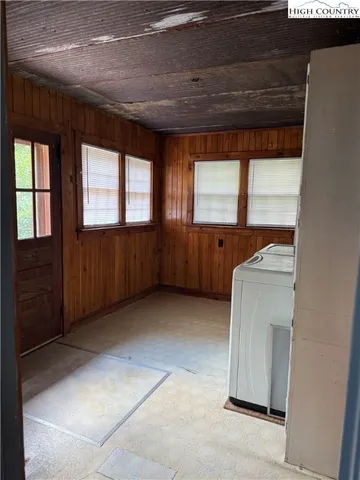 a view of an empty room with window and cabinet