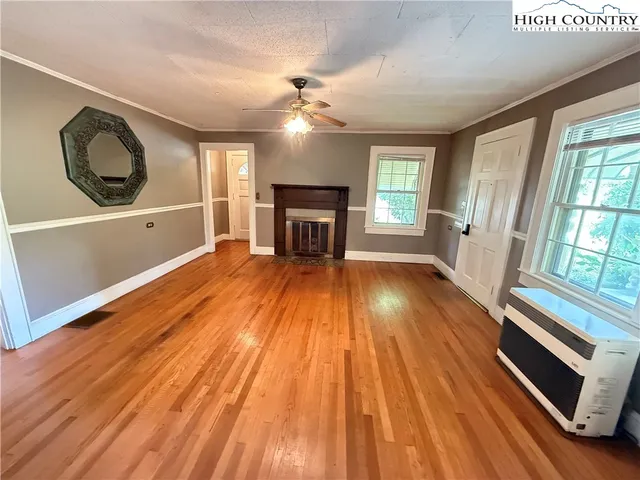 wooden floor in an empty room with a fireplace