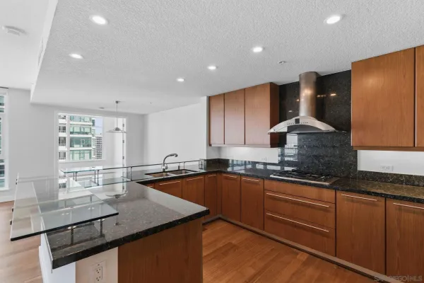 a kitchen with granite countertop stainless steel appliances and wooden cabinets