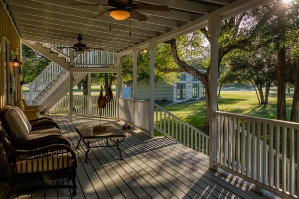 a view of a chairs and table in the balcony