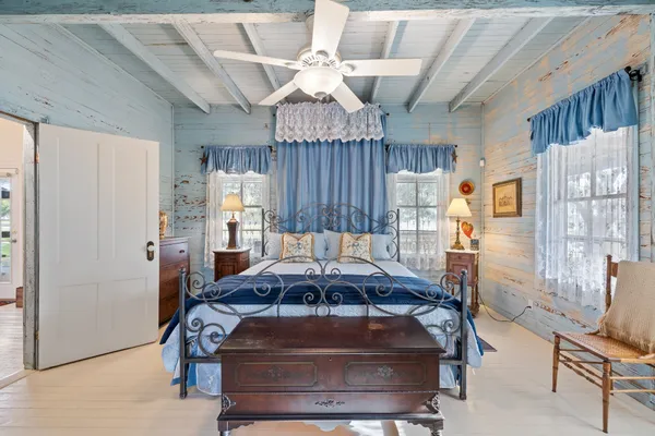 a living room with furniture a chandelier and a dining table